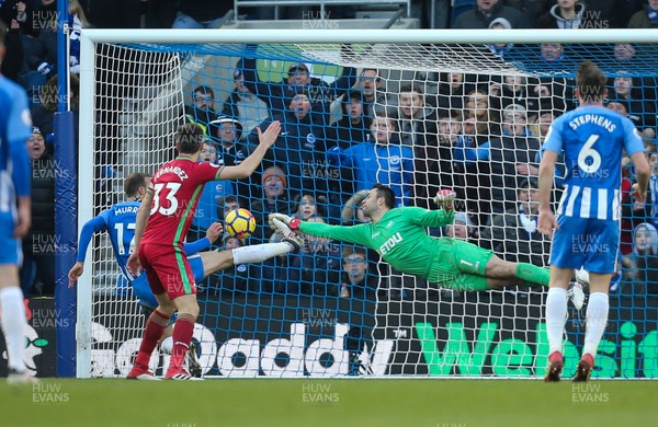 240218 - Brighton and Hove Albion v Swansea City, Premier League - Swansea City goalkeeper Lukasz Fabianski dives to save on the line from Glenn Murray of Brighton