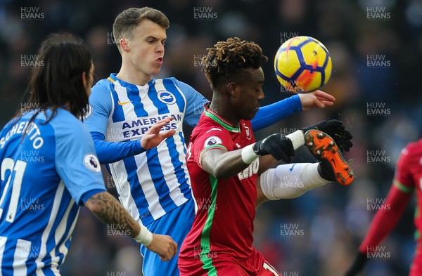 240218 - Brighton and Hove Albion v Swansea City, Premier League - Tammy Abraham of Swansea City and Solly March of Brighton compete for the ball