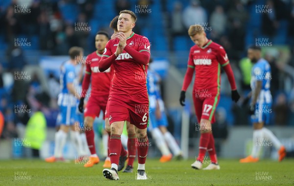 240218 - Brighton and Hove Albion v Swansea City, Premier League - Alfie Mawson of Swansea City leads the players as he applauds the fans at the end of the match