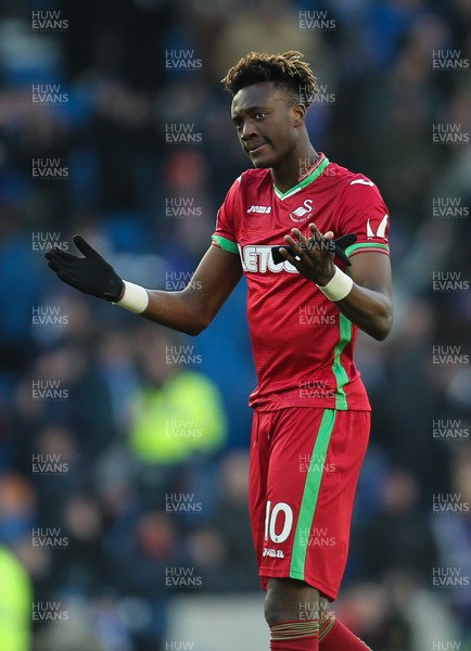 240218 - Brighton and Hove Albion v Swansea City, Premier League - Tammy Abraham of Swansea City shrugs his shoulders as he applauds the fans at the end of the match