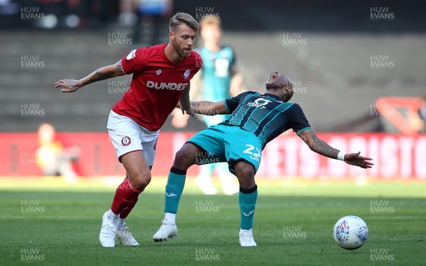 210919 - Bristol City v Swansea City - SkyBet Championship - Andre Ayew of Swansea City is taken down by Nathan Baker of Bristol City