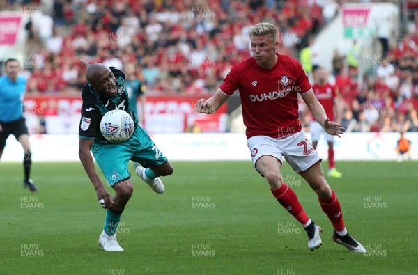 210919 - Bristol City v Swansea City - SkyBet Championship - Andre Ayew of Swansea City is tackled by Taylor Moore of Bristol City