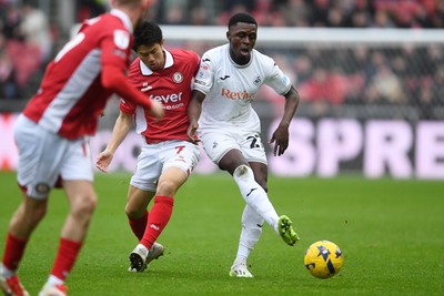 221125 - Bristol City v Swansea City - Sky Bet Championship - Zeidane Inoussa of Swansea City is challenged by Yu Hirakawa of Bristol City