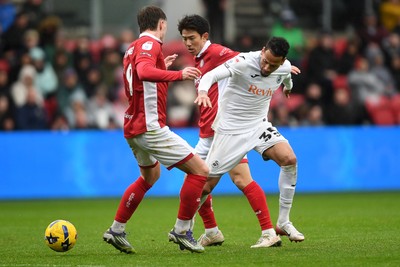 221125 - Bristol City v Swansea City - Sky Bet Championship - Ronald of Swansea City is challenged by Yu Hirakawa of Bristol City