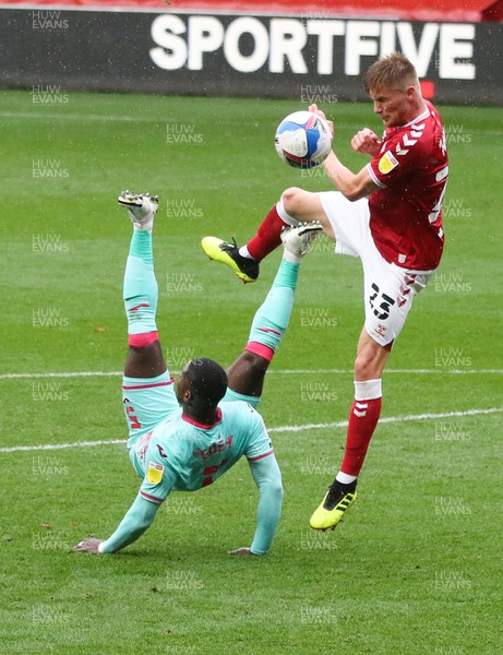 241020 - Bristol City v Swansea City, Sky Bet Championship - Marc Guehi of Swansea City attempts an overhead shot at goal as Taylor Moore of Bristol City closes in