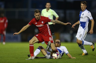 110816 - Bristol Rovers v Cardiff City - EFL Cup - Joe Ralls of Cardiff City is tackled Stuart Sinclair of Bristol Rovers