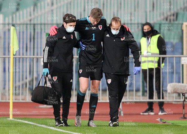 141020 - Bulgaria v Wales - UEFA Nations League - Wayne Hennessey of Wales comes off the field field injured with help from FAW staff