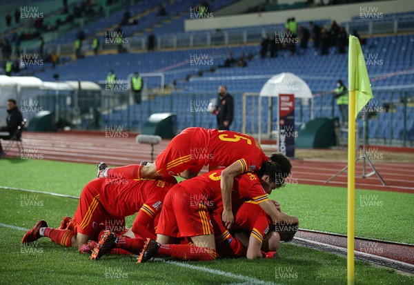 141020 - Bulgaria v Wales - UEFA Nations League - Jonny Williams of Wales is piled on as him and team mates celebrate his goal late in the second half