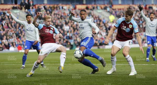130419 - Burnley v Cardiff City - Premier League -  Kenneth Zohore of Cardiff tries a shot on goal but is impeded by James Tarkowski of Burnley and Ben Mee of Burnley