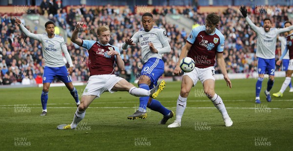 130419 - Burnley v Cardiff City - Premier League -  Kenneth Zohore of Cardiff tries a shot on goal but is impeded by James Tarkowski of Burnley and Ben Mee of Burnley Calls for penalty agreed by referee Mike Dean
