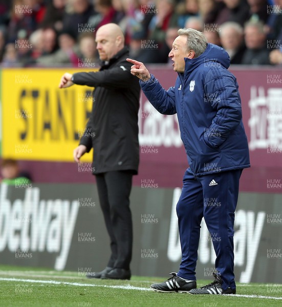 130419 - Burnley v Cardiff City - Premier League -  Manager Neil Warnock of Cardiff screams at players whilst Burnley manger Sean Dyche looks at watch