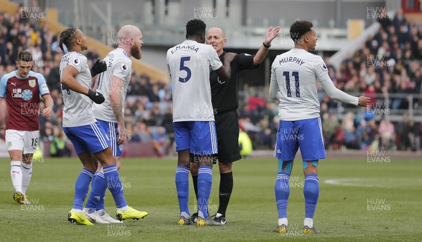 130419 - Burnley v Cardiff City - Premier League -  2nd penalty appeal not given to Cardiff as Referee Mike Dean closes his eyes to protests from Cardiff players and Bruno Ecuele Manga of Cardiff hangs onto ref's shoulders