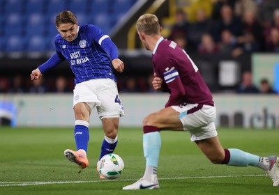 230925 - Burnley v Cardiff City - Carabao Cup Third Round - Cian Ashford of Cardiff puts the ball past Joe Worrall of Burnley