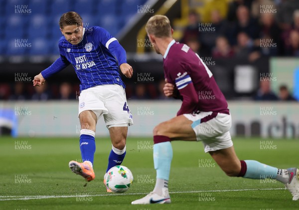 230925 - Burnley v Cardiff City - Carabao Cup Third Round - Cian Ashford of Cardiff puts the ball past Joe Worrall of Burnley