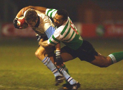 140203 - Caerphilly v Ebbw Vale - Welsh Premiership - Ebbw Vale's Andrew Bevan is brought down by Taunaholo Taufahema