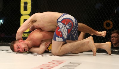 081218 - Cage Warriors 100 - Wales' Kris Edwards (grey shorts) v Aidan Stephen (blue and white shorts) during their Featherweight fight