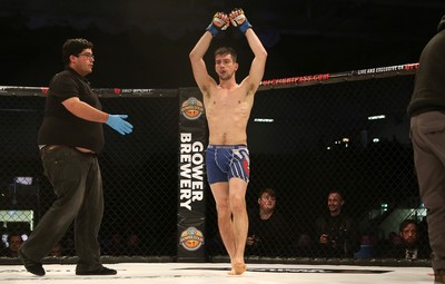 081218 - Cage Warriors 100 - Aidan Stephen celebrates his win over Wales' Kris Edwards