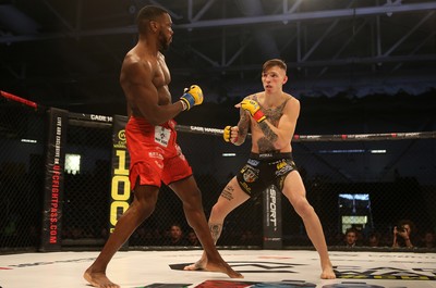 081218 - Cage Warriors 100 - Rhys McKee (Black shorts) v Jefferson George (Red shorts) during their lightweight fight