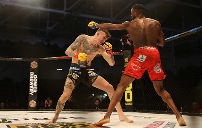 081218 - Cage Warriors 100 - Rhys McKee (Black shorts) v Jefferson George (Red shorts) during their lightweight fight