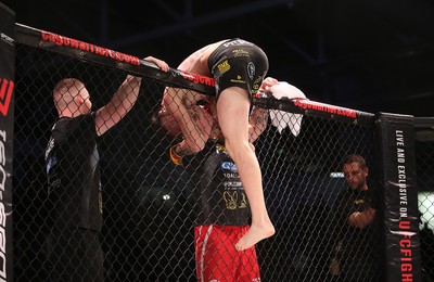 081218 - Cage Warriors 100 - Rhys McKee celebrates with coaches after victory over Jefferson George