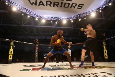 081218 - Cage Warriors 100 - Alex Lohore (Blue shorts) v Tim Barnett (Black shorts) during their Welterweight fight