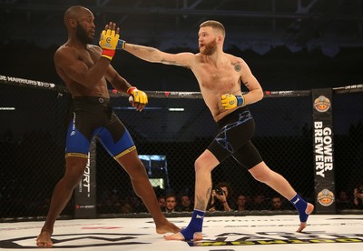 081218 - Cage Warriors 100 - Alex Lohore (Blue shorts) v Tim Barnett (Black shorts) during their Welterweight fight