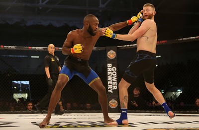 081218 - Cage Warriors 100 - Alex Lohore (Blue shorts) v Tim Barnett (Black shorts) during their Welterweight fight