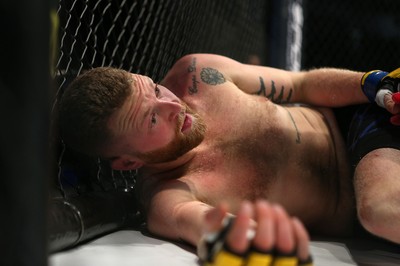 081218 - Cage Warriors 100 - Tim Barnett (Black shorts) lies on the ground after being defeated by Alex Lohore