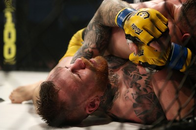 081218 - Cage Warriors 100 - Nicolas Dalby (Yellow shorts) v Philip Mulpeter (blue shorts) during their welterweight fight