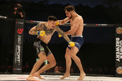 081218 - Cage Warriors 100 - Hakon Foss (black shorts) v Aaron Khalid of Wales (blue shorts) during their Welterweight fight