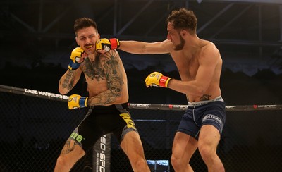 081218 - Cage Warriors 100 - Hakon Foss (black shorts) v Aaron Khalid of Wales (blue shorts) during their Welterweight fight