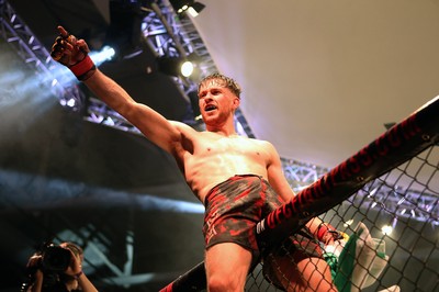 091218 - Cage Warriors 100 - Wales' Jack Shore celebrates victory over Mike Ekundayo to win the world title