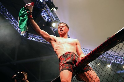 091218 - Cage Warriors 100 - Wales' Jack Shore celebrates victory over Mike Ekundayo to win the world title