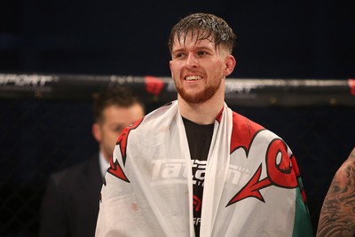 091218 - Cage Warriors 100 - Wales' Jack Shore celebrates victory over Mike Ekundayo to win the world title