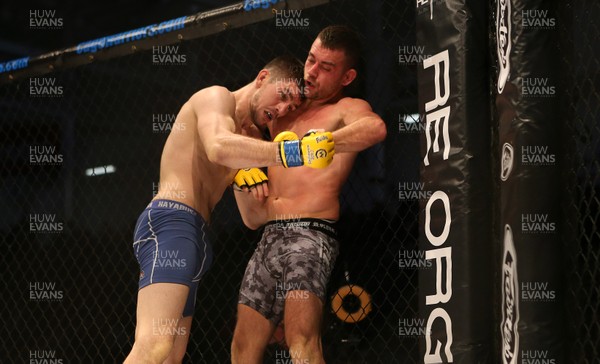081218 - Cage Warriors 100 - Wales' Kris Edwards (grey shorts) v Aidan Stephen (blue and white shorts) during their Featherweight fight