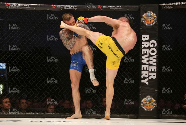 081218 - Cage Warriors 100 - Nicolas Dalby (Yellow shorts) v Philip Mulpeter (blue shorts) during their welterweight fight
