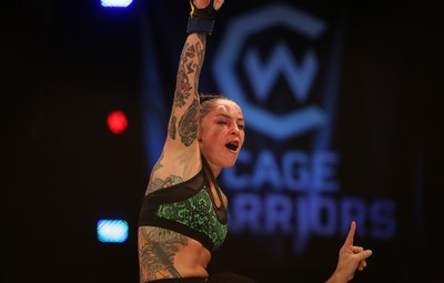 290918 - Cage Warriors 97 - Cory McKenna (Black Top) v Micol DiSegni (Green) - DiSiegni celebrates the win