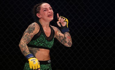 290918 - Cage Warriors 97 - Cory McKenna (Black Top) v Micol DiSegni (Green) - DiSiegni celebrates the win