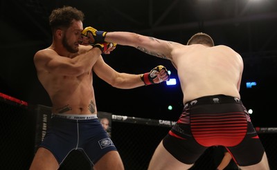 290918 - Cage Warriors 97 - Jamie Richardson (Black and red shorts) v Pontypridd's Aaron Khalid (Blue shorts)