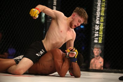 290918 - Cage Warriors 97 - Wales' Jack Shore (Black shorts) v Wesley Maia (White shorts) - Shore finishes off Maia