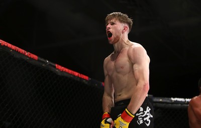 290918 - Cage Warriors 97 - Wales' Jack Shore (Black shorts) v Wesley Maia (White shorts) - Shore celebrates the victory in style