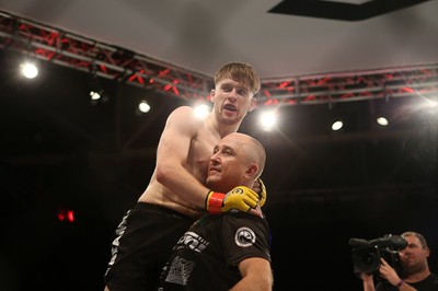 290918 - Cage Warriors 97 - Wales' Jack Shore (Black shorts) v Wesley Maia (White shorts) - Shore celebrates the victory in style