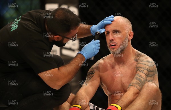 290918 - Cage Warriors 97 - Wales' Liam Bennett is looked over by a medic
