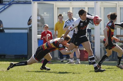 17.04.10 Carmarthen Quins RFC v Pontypridd RFC - Swales Cup semi final - Pontypridd's Chris Clayton is tackled by Carmarthen's Andrew Banfield. 