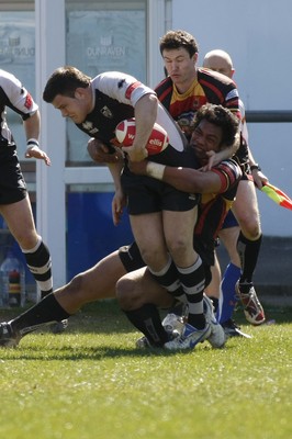 17.04.10 Carmarthen Quins RFC v Pontypridd RFC - Swales Cup semi final - Pontypridd's Adam Thomas is tackled by Carmarthen's Sione Timami. 