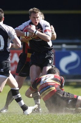 17.04.10 Carmarthen Quins RFC v Pontypridd RFC - Swalec Cup semi final - Pontypridd's Aaron Bramwell is wrapped up by Carmarthen's Tristan Davies(12) & Andrew Banfield. 