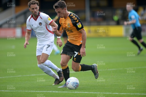 100819 - Cambridge United v Newport County - Sky Bet League 2 -  Luke Hannant of Cambridge is watched by Newports Robbie Willmott