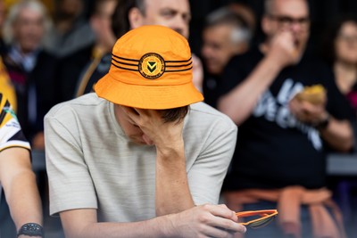 300825 - Cambridge United v Newport County - Sky Bet League 2 - A dejected Newport County fan