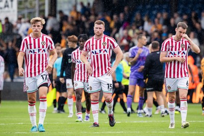 300825 - Cambridge United v Newport County - Sky Bet League 2 - Newport County’s Tom Davies, Newport County’s Lee Jenkins and Newport County’s Ciaran Brennan dejected after their sides defeat 