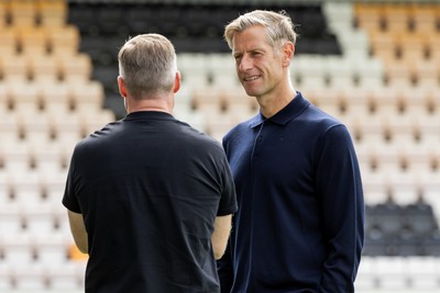 300825 - Cambridge United v Newport County - Sky Bet League 2 - Newport County manager David Hughes speaks to Cambridge United manager Neil Harris 